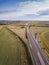 Aerial drone flight over road junction. Top view. Summer highway crossroad