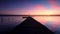 Aerial drone flight over small dock and boat at the lake, sunset