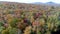 Aerial Drone - Fly Off Lake and Over Colorful Tree Canopy in Fall in Vermont