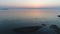 Aerial drone flying calm ocean at sunset