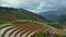 Aerial drone flying forward and tilt up to reveal terraced rice fields, Vietnam