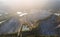 Aerial drone Flying over the granite quarry among the forest , cranes and equipment for production of granite and marble. Quarry