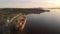 Aerial drone footage of a industrial grain elevator and a cargo ship being loaded in the port of Vancouver at sunset. 4K