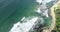 Aerial drone footage of ocean waves breaking on shore