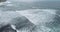 Aerial drone footage of ocean waves breaking on shore