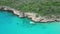 Aerial drone footage over Playa Porto Marie in West Punt Curaca. Carribean beach drop down footage over the clear sea