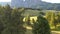 Aerial drone footage of small wooden huts in a rural area surrounded by rocky mountains