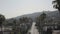 Aerial, drone footage of West Hollywood hills and tall palm trees along the streets in California