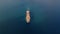 Aerial drone front top view video of ship sailing to port.