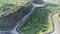 Aerial drone glides over an abandoned mine, capturing the eerie beauty of nature reclaiming manmade structures in Ranu