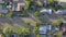 Aerial drone, houses and road in neighborhood of buildings or industrial architecture and trees. Top view of estate or