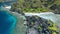 Aerial drone hover footage over hidden lagoon of star beach rocks on Tapiutan island near Matinloc shrine. El Nido