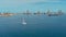 aerial drone image of the harbor with cargo container oil tanker ships and a sailboat at the approach area