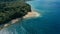 Aerial drone image of a remote south pacific island with sandy beach shore and beautiful ocean sea seascape and lush tropical