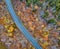 Aerial drone image of a vermont highway cutting through the autumn fall colored autumn trees