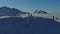 Aerial from drone pair of freeriders skier ski touring in the snowy mountains uphill in a line