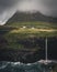 Aerial drone panorama of Gasadalur village and Mulafossur its iconic waterfall, Vagar, Faroe Islands, Denmark. Rough see