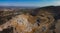 Aerial drone panorama of an open mine or quarry on a sunny day at Verd, Slovenia. Visible terraces and vast surface of sand and