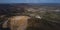 Aerial drone panorama of an open mine or quarry on a sunny day at Verd, Slovenia. Visible terraces and vast surface of sand and