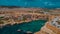 Aerial drone Panorama of picturesque bay in Malta called Popeye village, former movie set and now a beautiful beach with houses