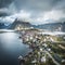 Aerial drone panoramic view of Reine traditional fishing village in the Lofoten archipelago in northen Norway with blue