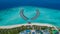 Aerial drone perspective shot of tropical isolated island resort at the indian ocean