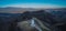 Aerial drone photo of cute fantastic charming Saint Primoz church on a small hill with mountains in background at sunset, Jamnik