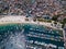 Aerial drone photo of fishing boats in the blue water. Brazilian city Arraial do Cabo and beach Praia dos Anjos