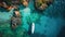 Aerial drone photo of luxury yacht anchored in tropical exotic island with crystal clear turquoise sea