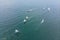 Aerial drone photo of young teenagers on small sailing boats competing in the regatta at mediterranean emerald sea