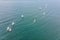 Aerial drone photo of young teenagers on small sailing boats competing in the regatta at mediterranean emerald sea