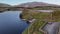 Aerial drone reveal shot of the boathouse at Llyn Dywarchen with Yr Wyddfa in the background
