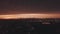 AERIAL: Drone Rising Up overlooking Brookyln with Manhattan Skyline in Background in Dark Orange Dawn Light