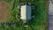 Aerial, Drone Shot, above on abandoned farmhouse surrounded by paddy rice field, in the city of Bekasi, on a sunny, summer day, in