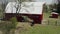 Aerial drone shot of american countryside landscape. Farm, red barn, Rural scenery, USA, move camera