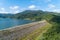 Aerial Drone shot bird eye view Blue sky with rainforest and road around dam