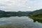 Aerial Drone shot bird eye view mountain lake with rainforest lake surrounded by mountains and reflection in the water