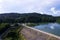 Aerial Drone shot bird eye view rainforest and road around the dam lake