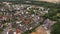 aerial drone shot from a bird's eye view of a typical small old town in germany, stadium and field