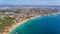 Aerial drone shot of a busy beach, amazing cliffs, vegetation and also buidlings in the background. Praia do Vau