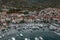 Aerial drone shot of empty riva in Komiza town port on Vis Island in morning before sunrise in Croatia summer