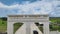 Aerial drone shot of empty trucks passing under the gate of special economic zone