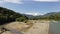 Aerial drone shot of a fast white alpine river. Beautiful view of mountain river Belaya on summer sunny morning in