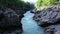 Aerial drone shot of a fast white alpine river. Beautiful view of mountain river Belaya on summer sunny morning in