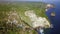 Aerial drone shot flying above amazing sea cliff at Kelingking beach of Nusa Penida in exotic holidays travel in Asia