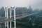 Aerial drone shot of flyover highway to E`GongYan Bridge withe Chinese name on bridge tower in Chongqing, China