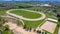 AERIAL: Drone shot of a hippodrome on the outskirts of Ljubljana on a sunny day.