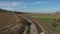 Aerial drone shot of Paver mover on a flat newly made road, ramming and leveling. Asphalt paver applying asphalt on the