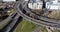 Aerial drone shot reveals spectacular elevated highway and convergence of roads, bridges, viaducts in Glasgow at sunset,