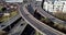 Aerial drone shot reveals spectacular elevated highway and convergence of roads, bridges, viaducts in Glasgow at sunset,